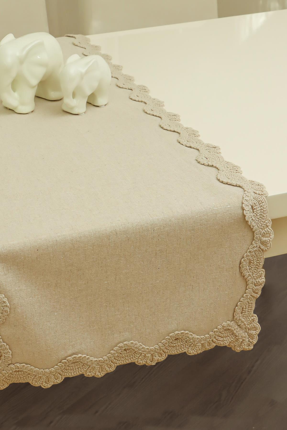 Chemin de table beige avec détails en dentelle, décoré d'une figurine d'éléphant en céramique, décoration de table élégante